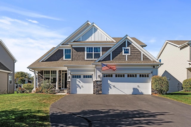 craftsman-style house featuring a front yard and a garage