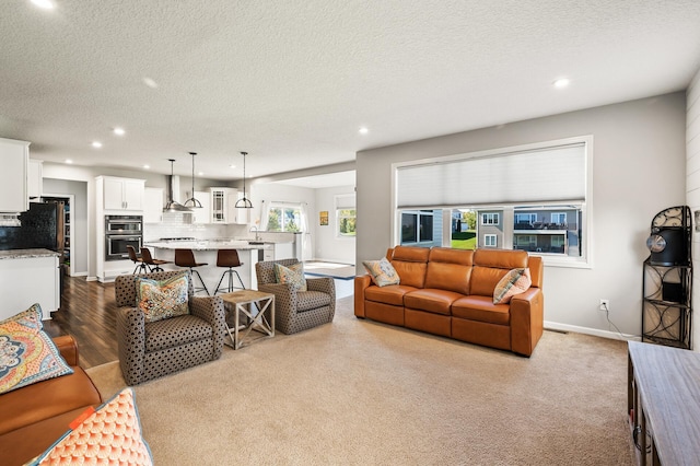 living room featuring light wood-type flooring and a textured ceiling