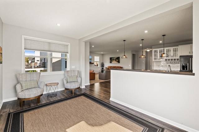 living room featuring dark hardwood / wood-style floors and sink