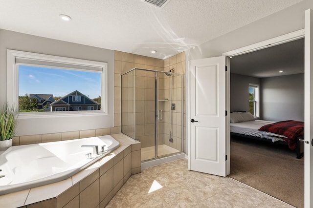 bathroom featuring shower with separate bathtub, tile patterned floors, a textured ceiling, and a healthy amount of sunlight