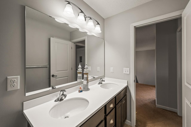 bathroom featuring a textured ceiling and vanity