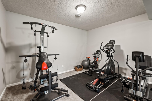 exercise room featuring carpet floors and a textured ceiling