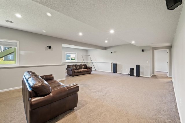 living room with light carpet, a wealth of natural light, and a textured ceiling