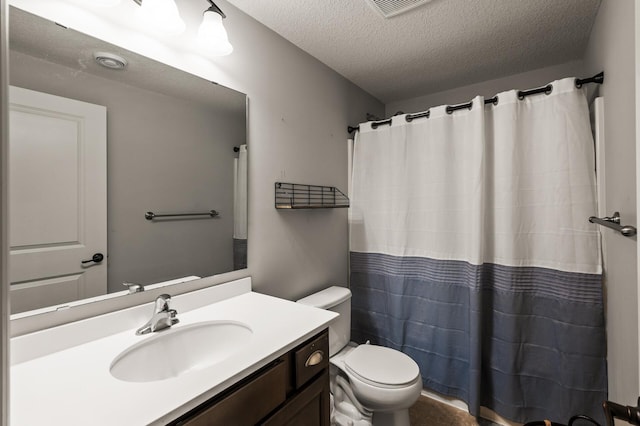 bathroom with a textured ceiling, curtained shower, vanity, and toilet