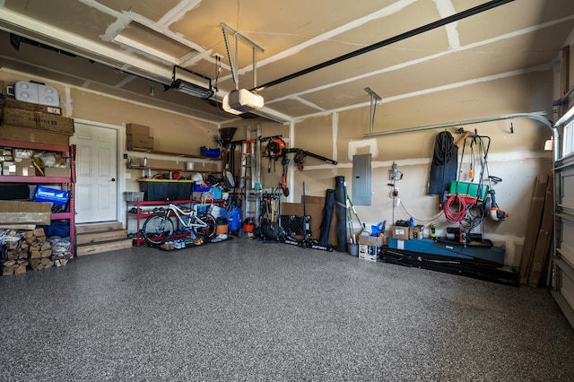 garage with a garage door opener and electric panel