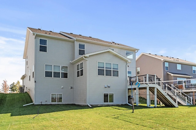 rear view of house featuring cooling unit, a yard, and a wooden deck