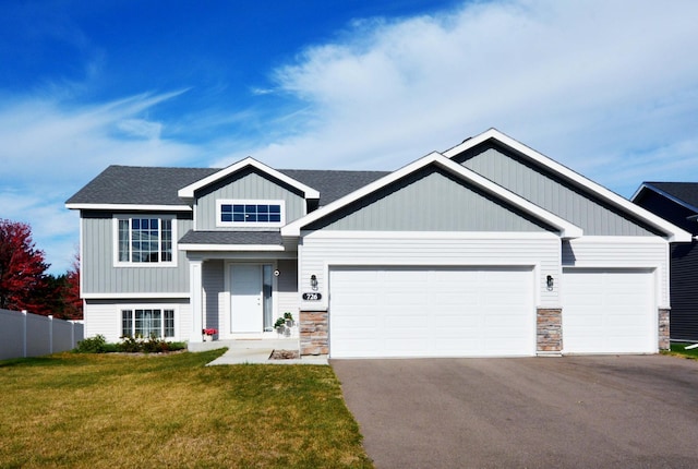 view of front of property with a garage and a front yard