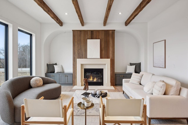 living room featuring light hardwood / wood-style flooring and beam ceiling