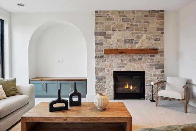 carpeted living room with a fireplace