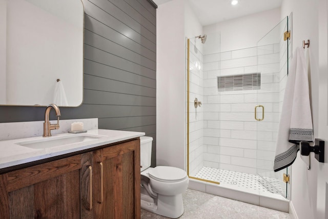 bathroom with vanity, toilet, and a shower with shower door