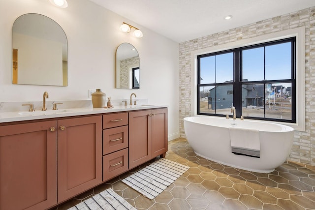 bathroom with tile walls, vanity, and a bathing tub