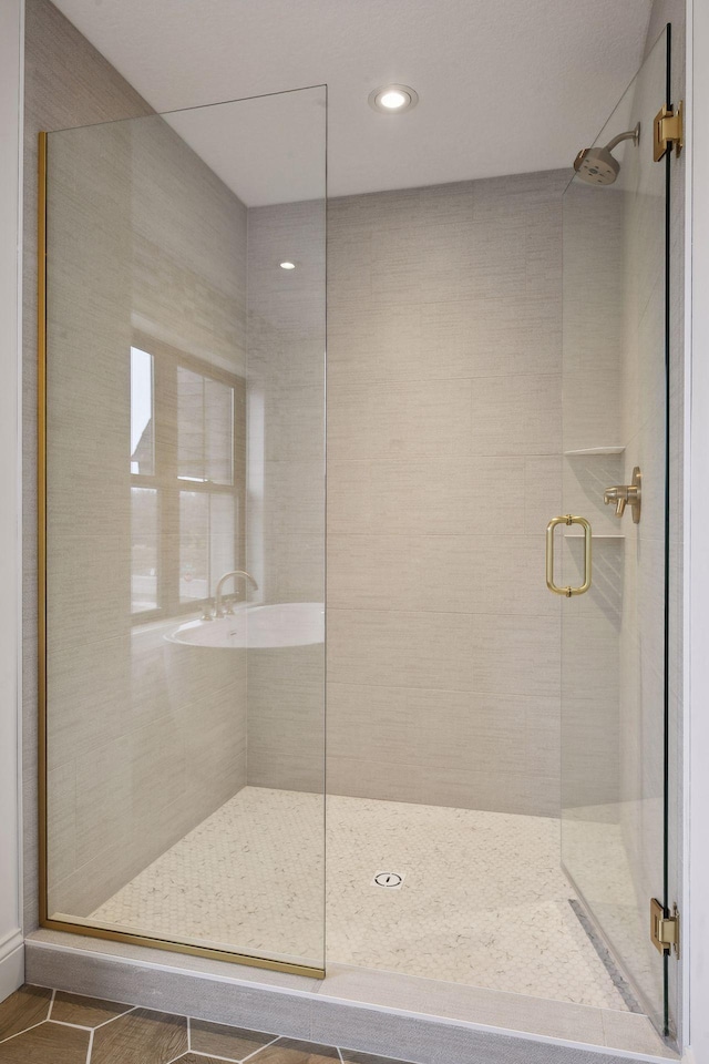 bathroom with walk in shower and tile patterned floors