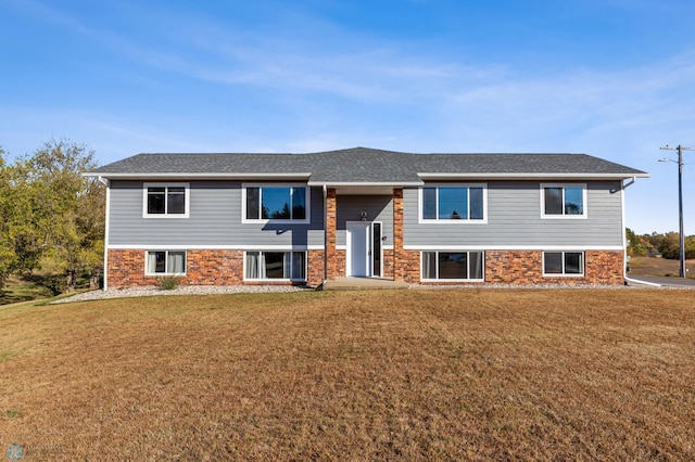 raised ranch featuring a front yard