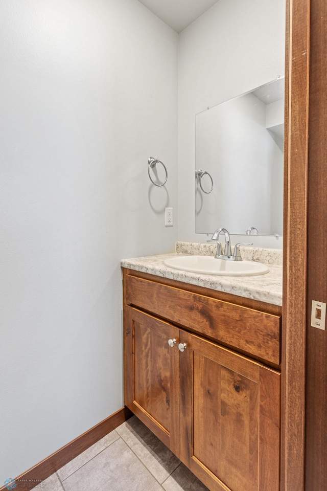 bathroom with baseboards, tile patterned flooring, and vanity