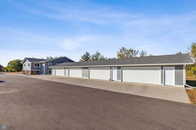 garage featuring concrete driveway