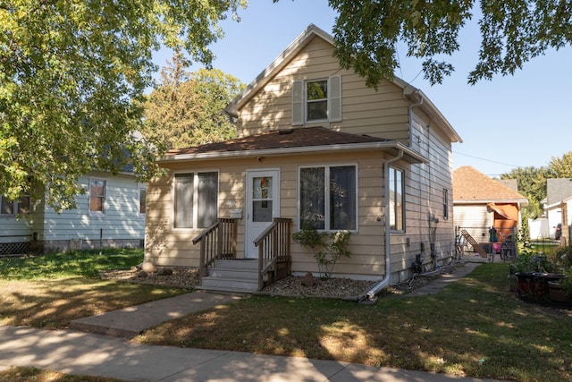 bungalow-style house with a front lawn