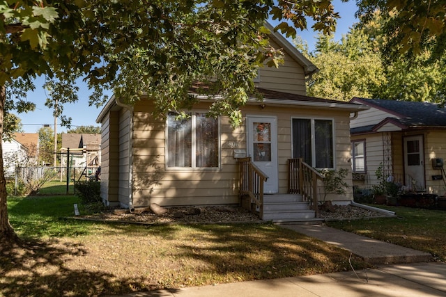 bungalow-style home featuring a front yard