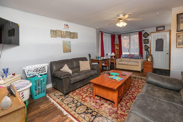 living room with ceiling fan and dark hardwood / wood-style floors