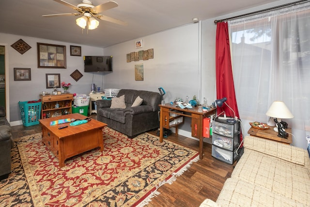 living room with ceiling fan and dark hardwood / wood-style flooring