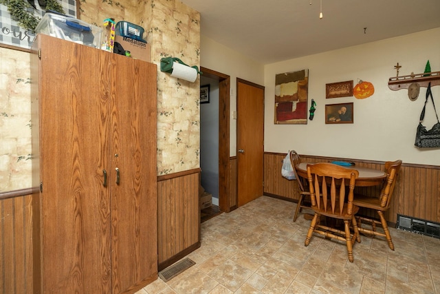 dining space with wooden walls