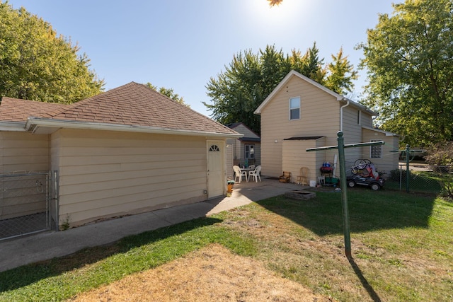 rear view of house featuring a yard and a patio area