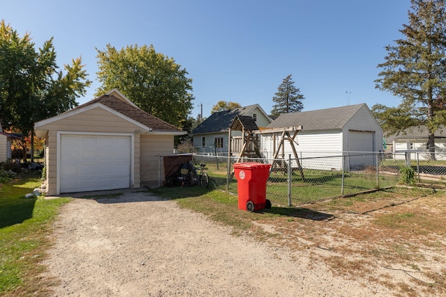 view of front of home featuring a garage and an outdoor structure