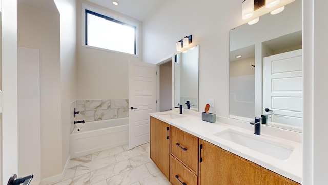 bathroom with vanity and a washtub