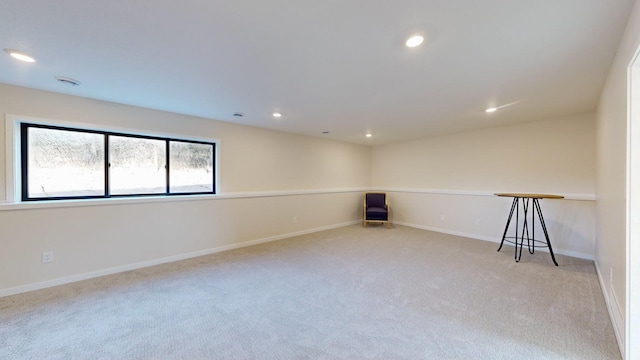 unfurnished room featuring light carpet