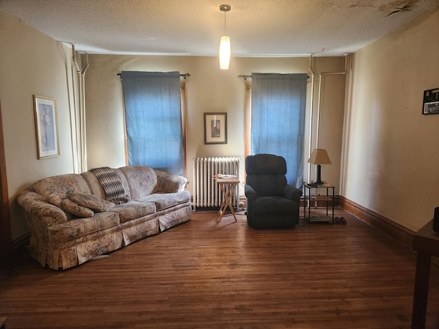 living room with a textured ceiling, radiator, and dark hardwood / wood-style floors