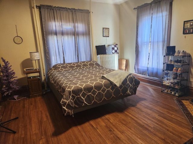 bedroom with dark wood-type flooring