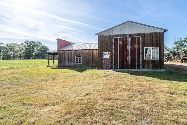 view of outbuilding with a lawn