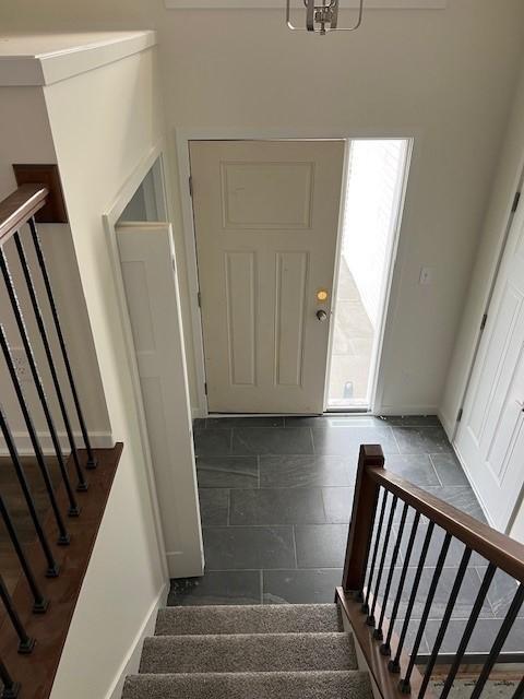 foyer with a chandelier