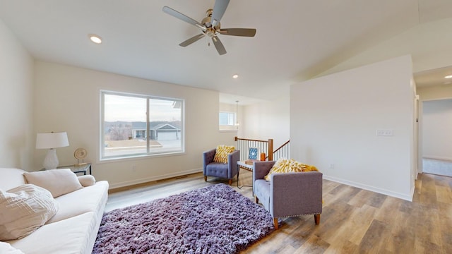 living area featuring light hardwood / wood-style floors and ceiling fan