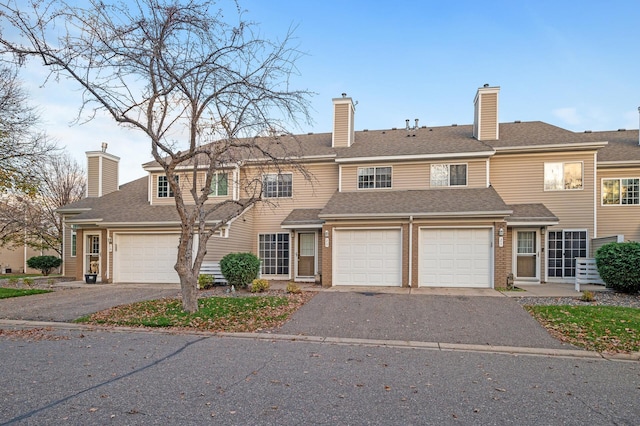 townhome / multi-family property featuring a garage