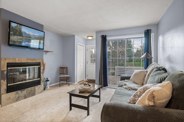 living room featuring a textured ceiling, light colored carpet, and a tiled fireplace