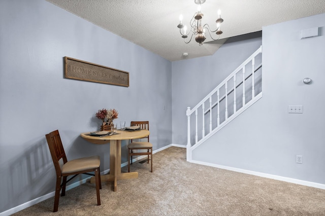 dining area with carpet floors, a notable chandelier, and a textured ceiling