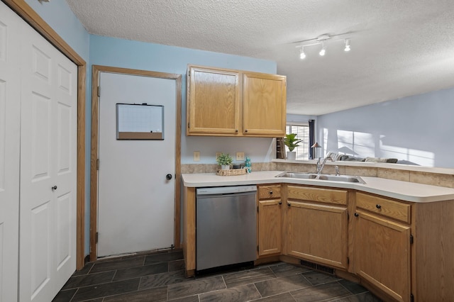 kitchen with dishwasher, sink, kitchen peninsula, and a textured ceiling