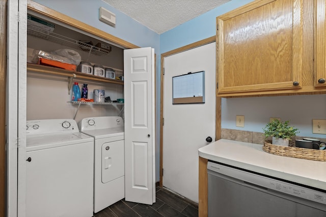 clothes washing area featuring washer and dryer and a textured ceiling