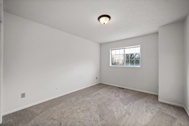 empty room featuring carpet floors and a textured ceiling