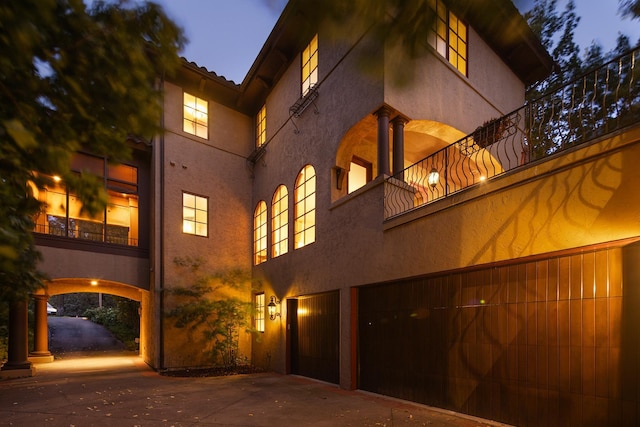 back house at dusk with a balcony