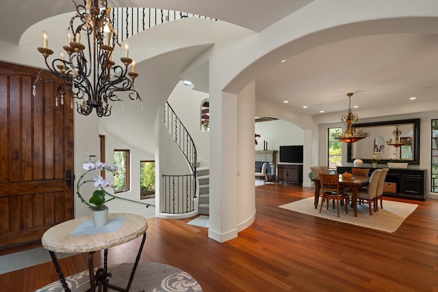 foyer entrance featuring wood-type flooring and a notable chandelier