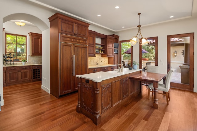 kitchen featuring paneled built in refrigerator, a wealth of natural light, and tasteful backsplash