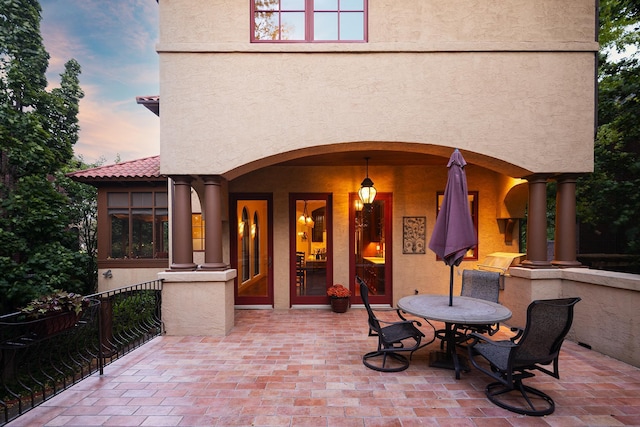 view of patio terrace at dusk