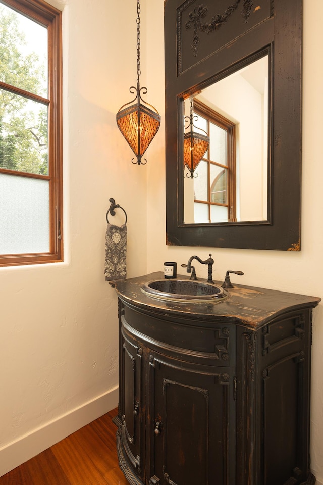 bathroom with hardwood / wood-style floors and vanity