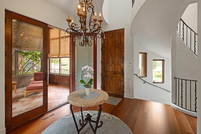 interior space with wood-type flooring and an inviting chandelier