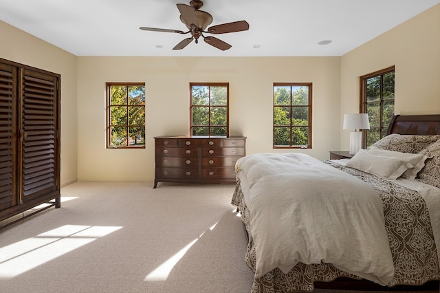 carpeted bedroom featuring ceiling fan