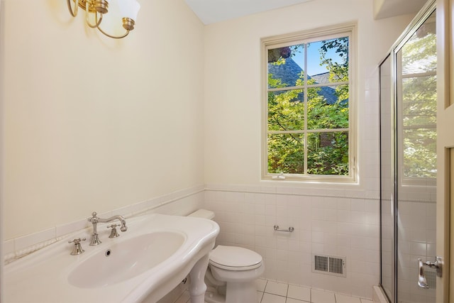 bathroom featuring a healthy amount of sunlight, tile patterned flooring, toilet, and sink