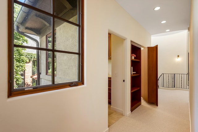 corridor with light colored carpet