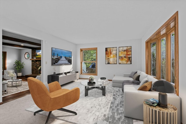 living room featuring a fireplace, wood-type flooring, and plenty of natural light