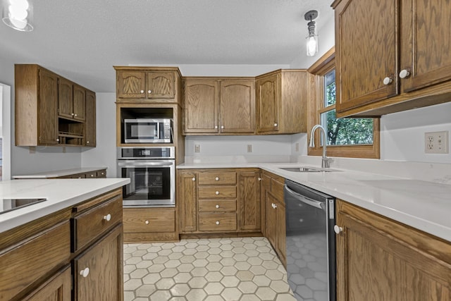 kitchen featuring sink, stainless steel appliances, and a textured ceiling